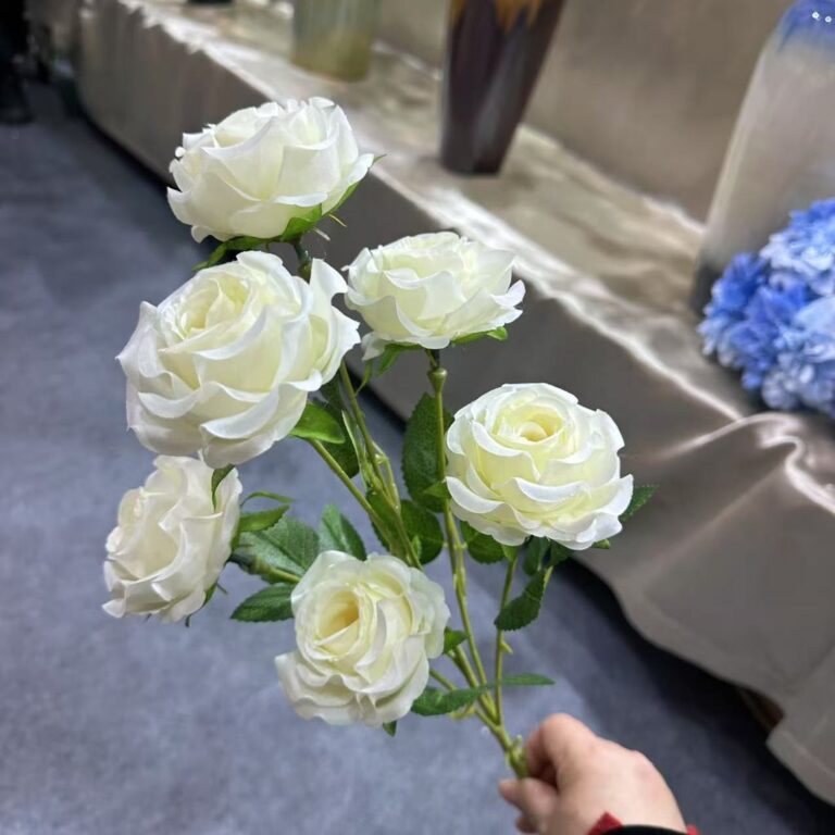 Cluster of creamy white artificial silk roses for elegant home decor accents.