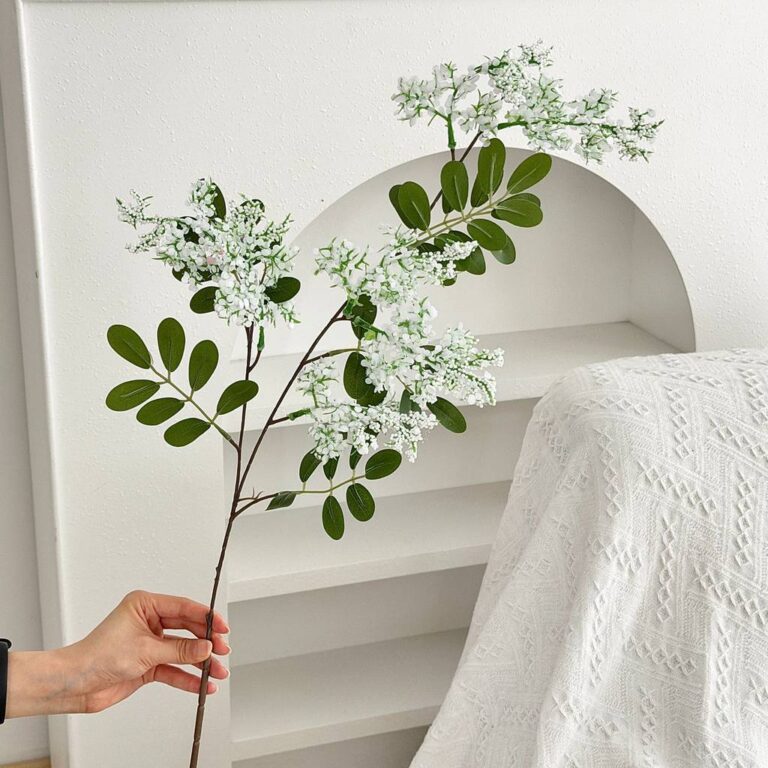 Realistic artificial flower branch with white blossoms, ideal for home decor accents.