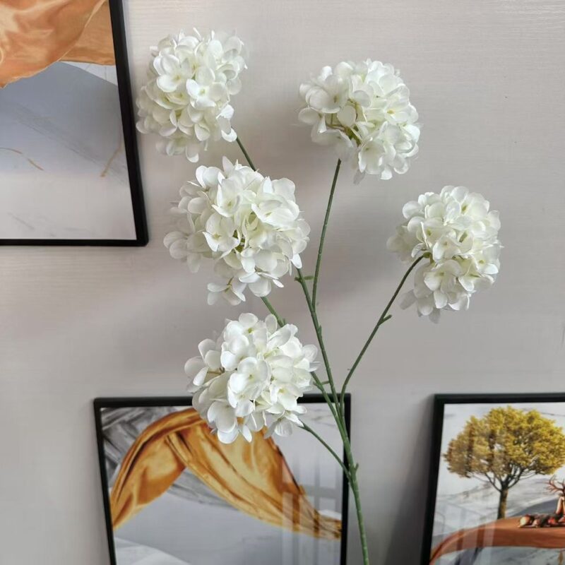 Bouquet of artificial white silk hydrangea flowers with elegant stems.