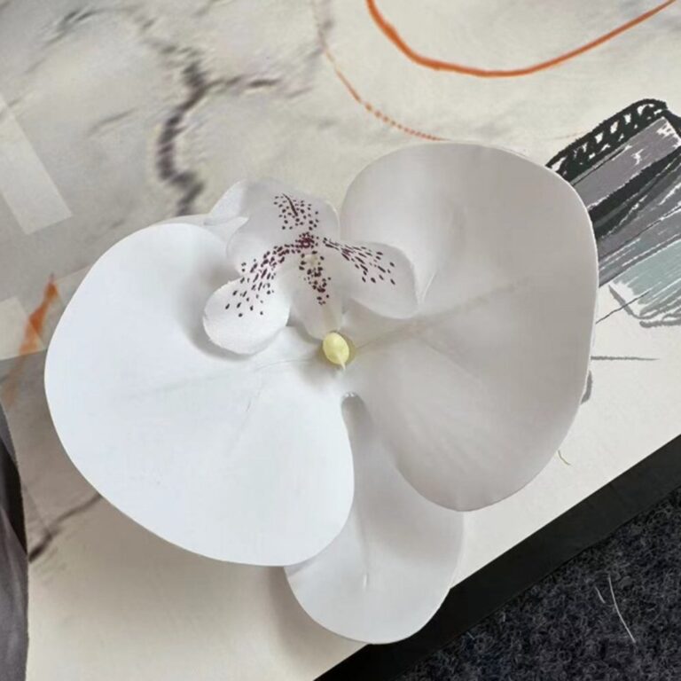White 3D silk orchid head decor featuring realistic petals and speckled centers for home accents.