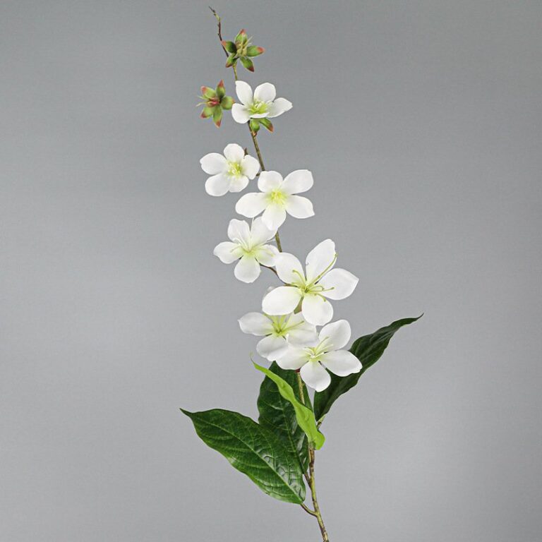 Artificial flower branch of white silk crabapple blossoms on green leaves.