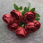 Realistic bouquet of seven red silk roses and foliage, perfect for everlasting home decor arrangements.