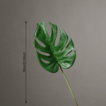 Large artificial Monstera deliciosa leaf made from silk flower material.