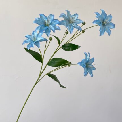 Branch of faux blue lilies, a realistic artificial flower perfect for wedding decorations.