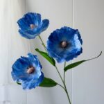 Three realistic blue silk poppy flowers, perfect for faux wedding accents and decoration.
