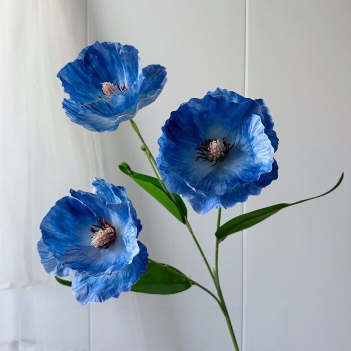 Three realistic blue silk poppy flowers, perfect for faux wedding accents and decoration.