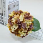 Realistic silk artificial hydrangea bouquet featuring cream, yellow, and dusty mauve blooms.