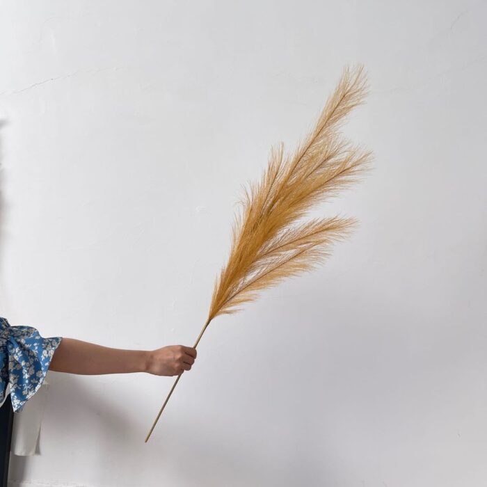 Elegant faux flower reed plume displayed, perfect for bohemian wedding decor and artificial arrangements.