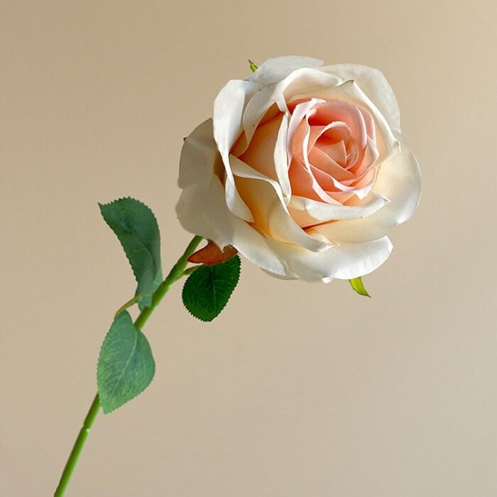 Cream silk rose, a beautiful artificial flower perfect for elegant wedding arrangements.