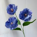 Realistic artificial flower bouquet of blue silk poppies for faux wedding flowers and decor.