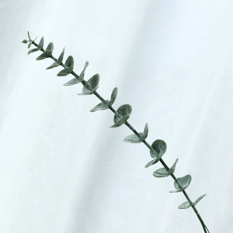 Realistic faux eucalyptus sprig, ideal for wedding bouquets and decor.