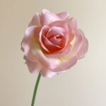 Beautiful artificial pink rose, perfect for adding a real touch to wedding decor.