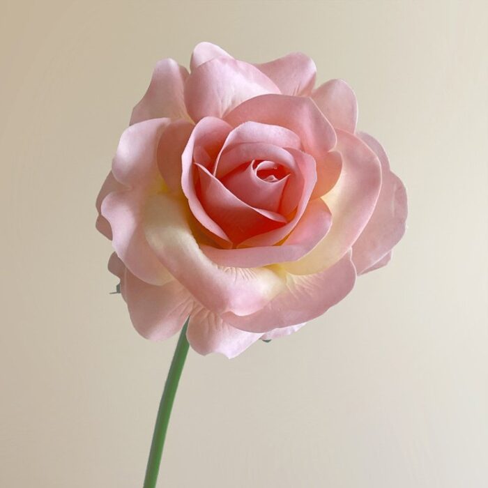 Beautiful artificial pink rose, perfect for adding a real touch to wedding decor.