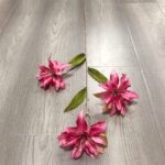 Three realistic pink silk lily blooms perfect for faux wedding flowers decor on a wood floor.