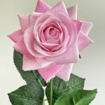Realistic pink faux rose, a high-quality artificial flower perfect for wedding arrangements and decor.