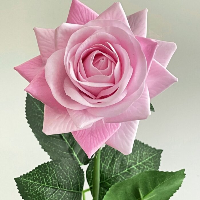 Realistic pink faux rose, a high-quality artificial flower perfect for wedding arrangements and decor.