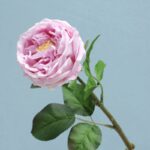 Soft pink real touch rose bloom on the stem, ideal for artificial flower arrangements.