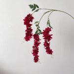 String of vibrant red faux wedding flowers designed for hanging decorations.