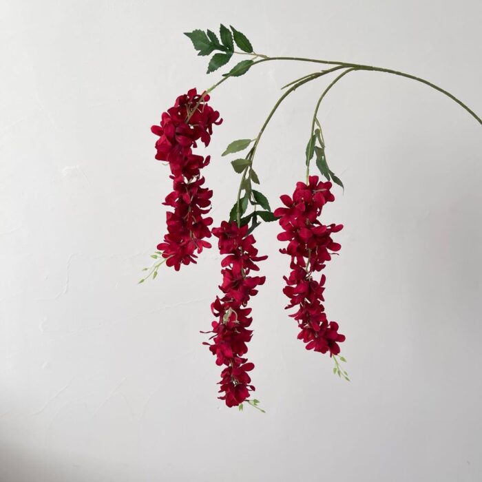 String of vibrant red faux wedding flowers designed for hanging decorations.