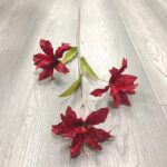 Three deep red faux lily heads, perfect artificial flower accents for wedding decor.