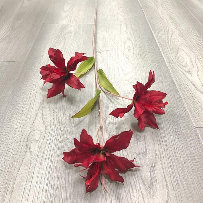 Three deep red faux lily heads, perfect artificial flower accents for wedding decor.