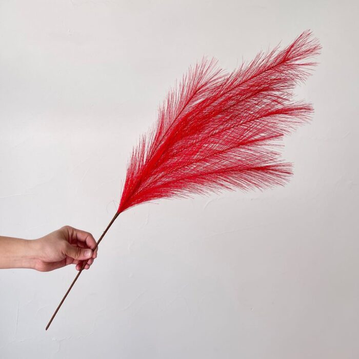 Striking red plastic feather reed used for decorative floral arrangements and faux wedding flowers.