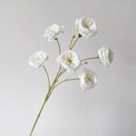 Six white artificial roses designed as faux wedding flowers for everlasting decor.