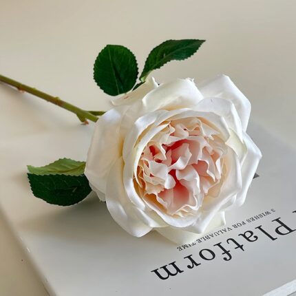 Realistic artificial flower silk rose for wedding decor, featuring lush petals and green leaves.