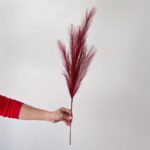 Red plastic reed artificial flower used for wedding decor and floral arrangements.