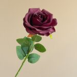 Deep burgundy silk rose with green leaves, ideal for realistic faux wedding flowers arrangements.