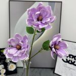 Three silk purple magnolia blooms, ideal faux wedding flowers for lasting decorative arrangements.