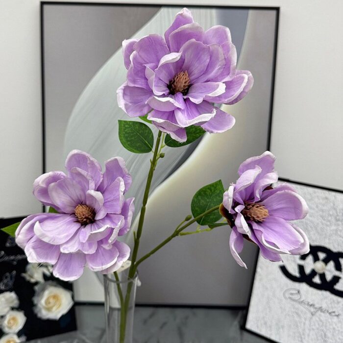 Three silk purple magnolia blooms, ideal faux wedding flowers for lasting decorative arrangements.