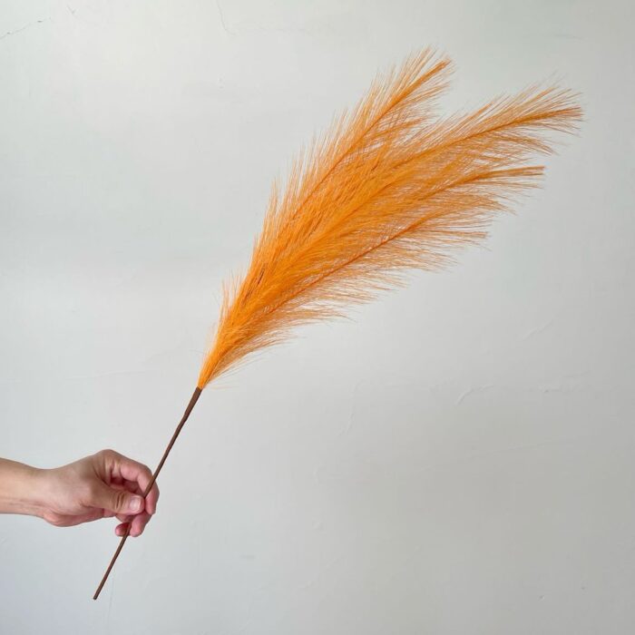 Bright orange artificial plume attached to a reed, ideal for creating faux wedding flowers and floral arrangements.