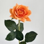 Realistic orange artificial flower rose with green leaves, perfect for faux wedding floral decor.