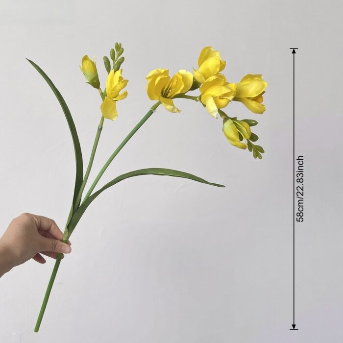 Spray of realistic yellow silk freesia, suitable for faux wedding flowers and decor.